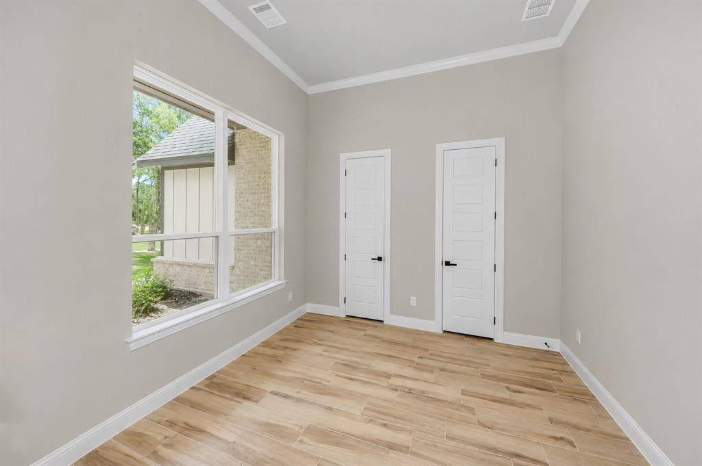 1057 Vh Ranch Poolville, TX 76487 - Photo 6 of 38 a view of an empty room with wooden floor and a window
