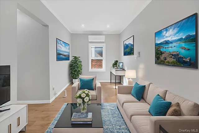a living room with furniture and painting on the wall