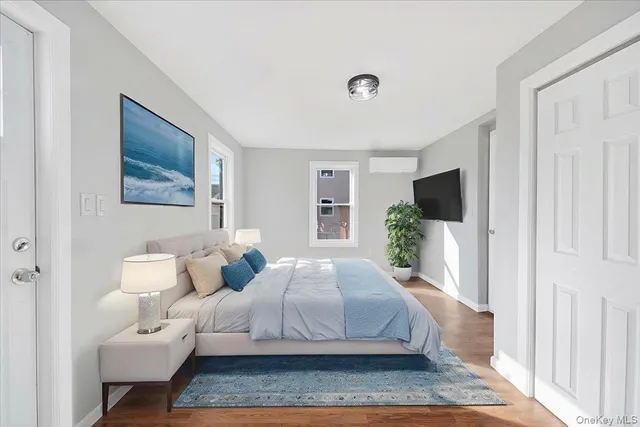 a bedroom with a large bed and a flat screen tv