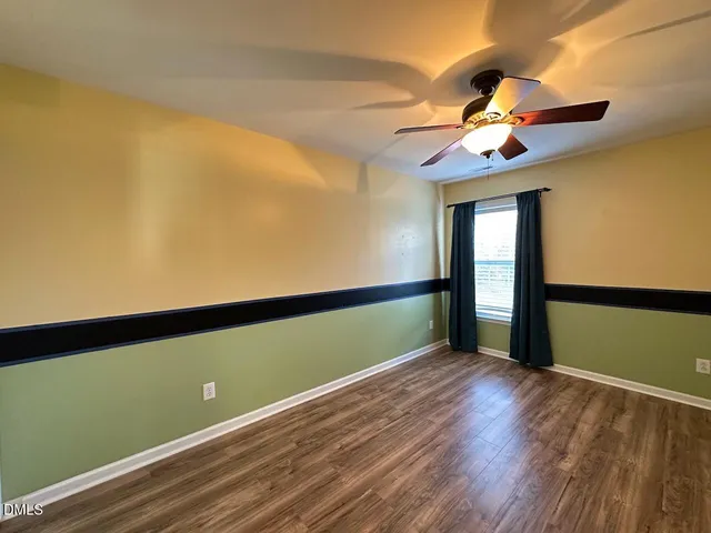 a view of room with window and ceiling fan