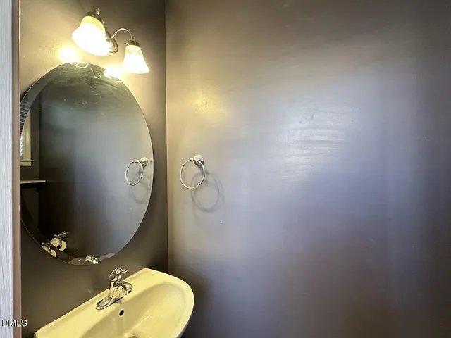 a bathroom with a sink mirror and toilet