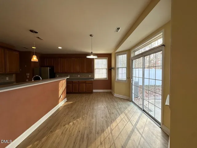 a large kitchen with stainless steel appliances granite countertop a large window a oven and a large window