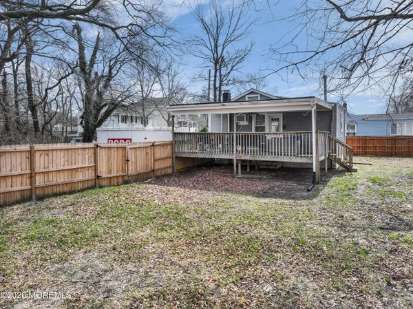 a view of a house with a yard and sitting area