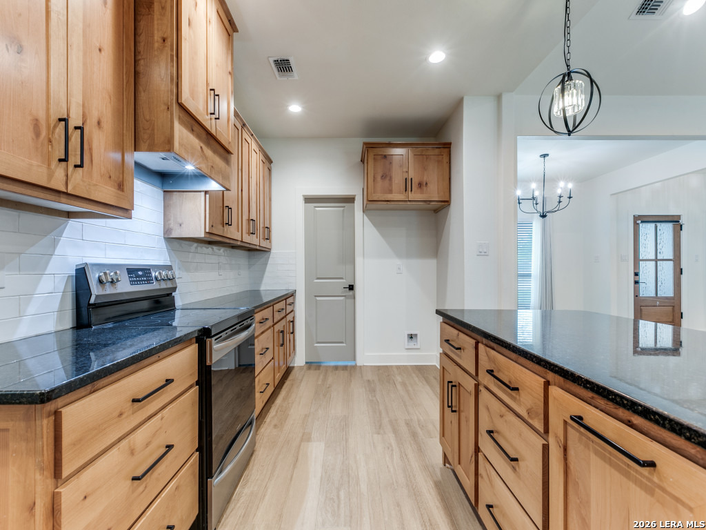 1015 Timbercrest Pleasanton, TX 78064 - Photo 11 of 26 a kitchen with stainless steel appliances granite countertop a sink a stove and cabinets