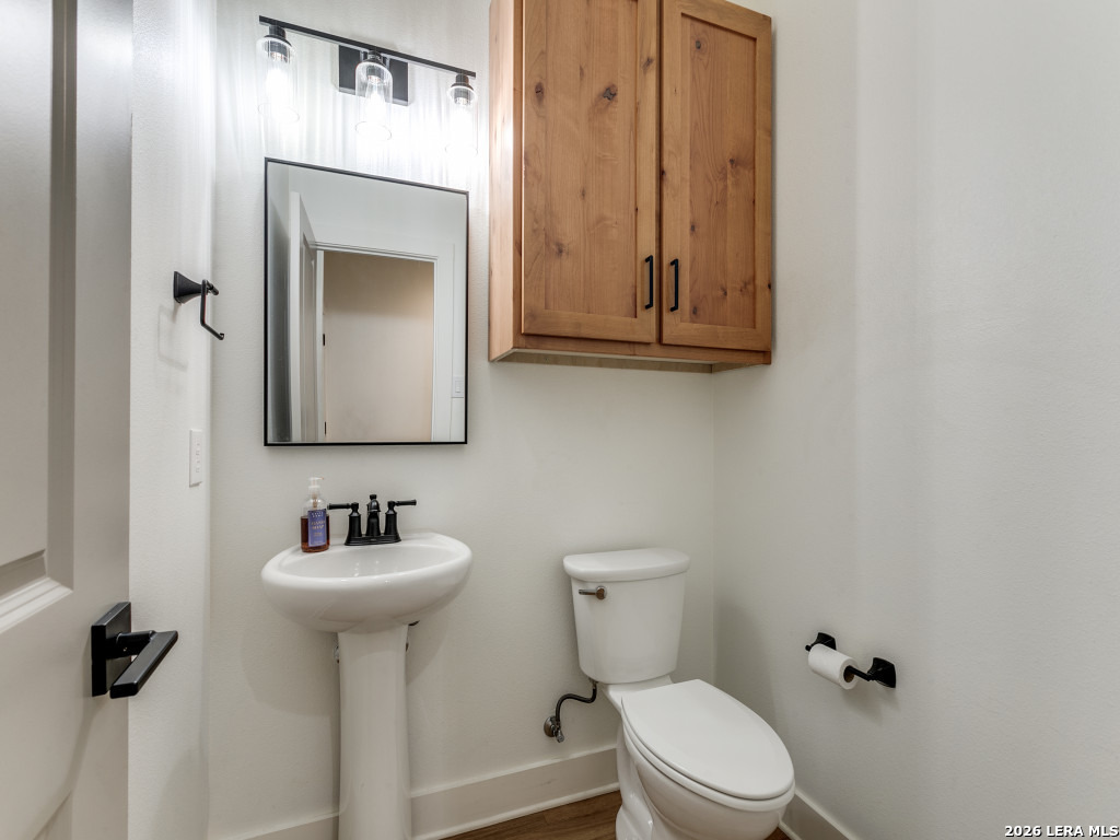 1015 Timbercrest Pleasanton, TX 78064 - Photo 13 of 26 a bathroom with a toilet sink and mirror