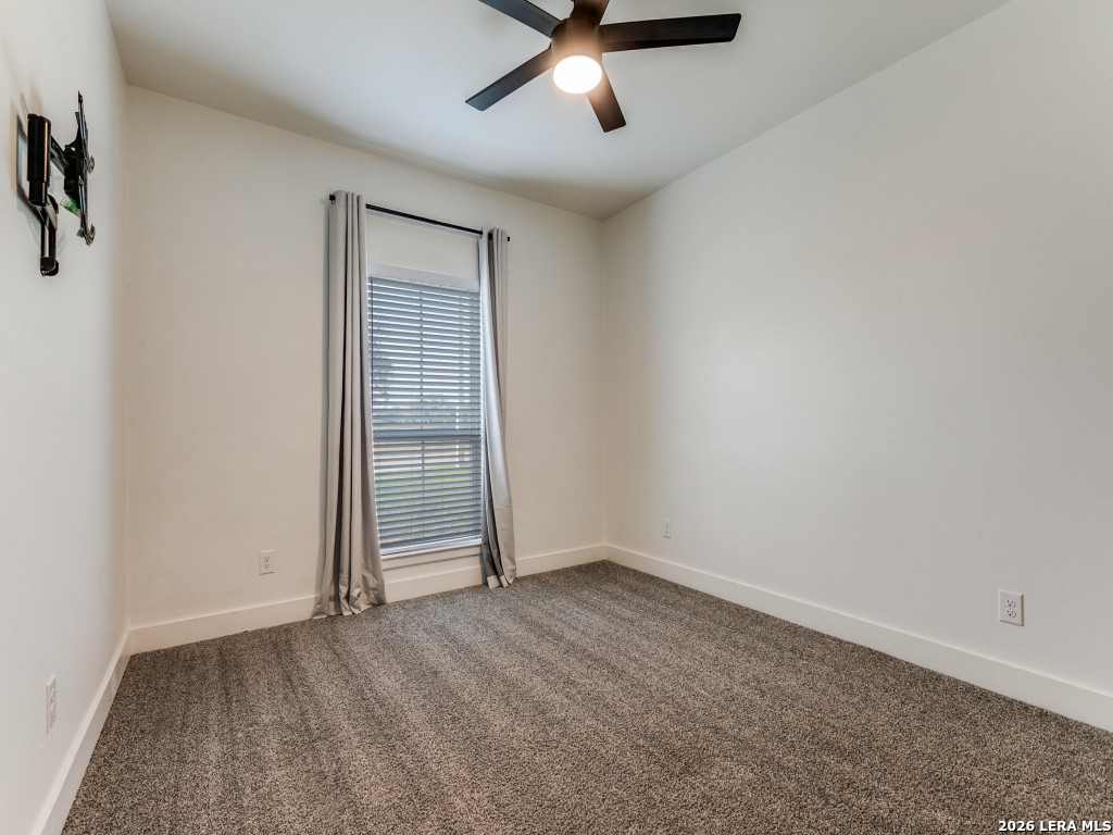 1015 Timbercrest Pleasanton, TX 78064 - Photo 18 of 26 an empty room with closet and windows