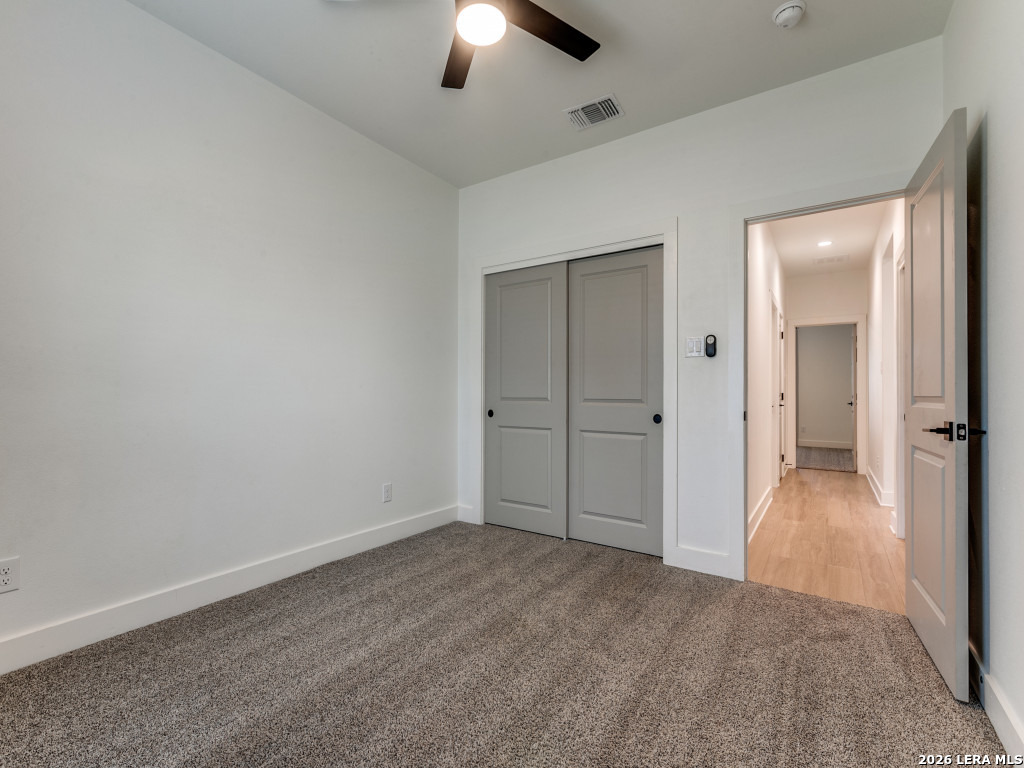 1015 Timbercrest Pleasanton, TX 78064 - Photo 19 of 26 an empty room with closet and a chandelier fan