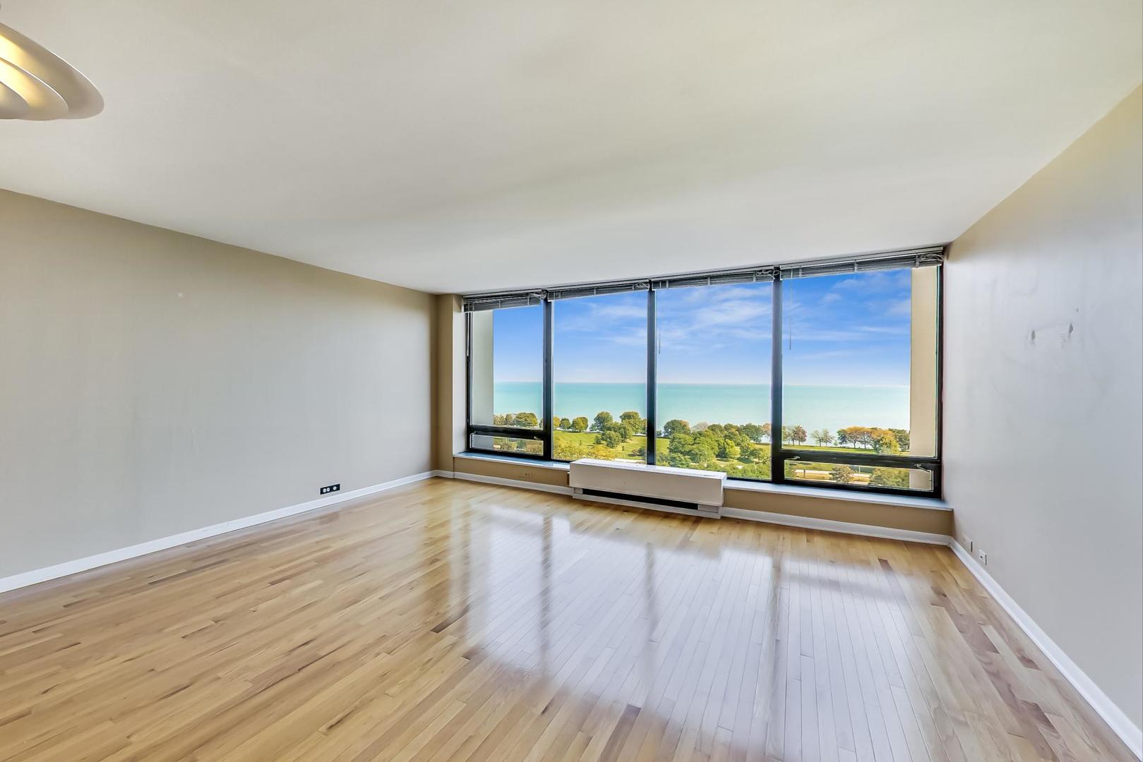 5445 North Sheridan Road, Unit 1706 Chicago, IL 60640 - Photo 2 of 26 wooden floor in an empty room with window