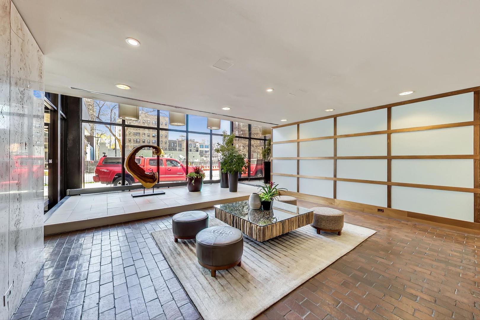 5445 North Sheridan Road, Unit 1706 Chicago, IL 60640 - Photo 18 of 26 an outdoor living room with furniture and a table