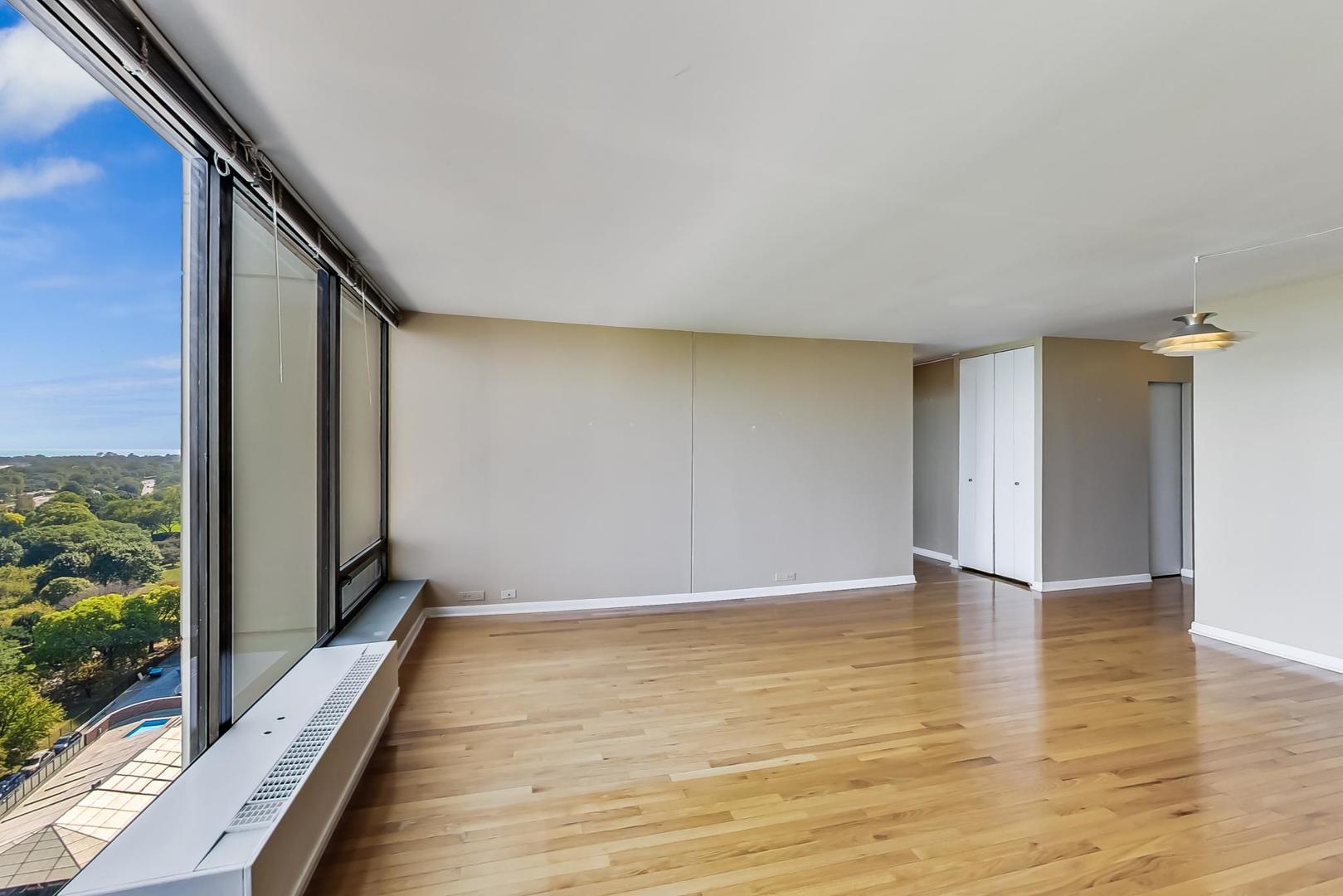 5445 North Sheridan Road, Unit 1706 Chicago, IL 60640 - Photo 4 of 26 a view of an empty room with wooden floor and a window