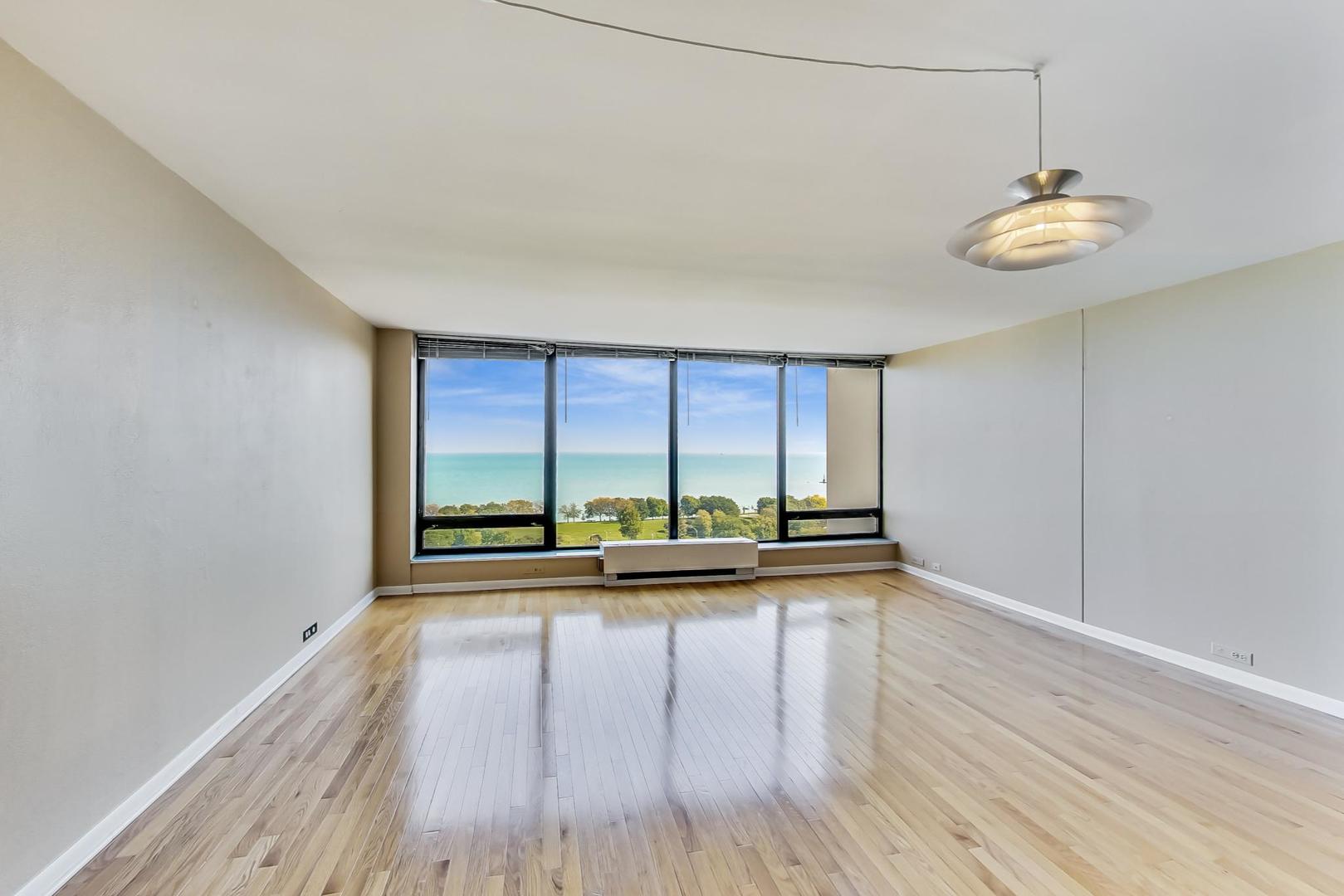 5445 North Sheridan Road, Unit 1706 Chicago, IL 60640 - Photo 5 of 26 a view of a room with wooden floor and fan