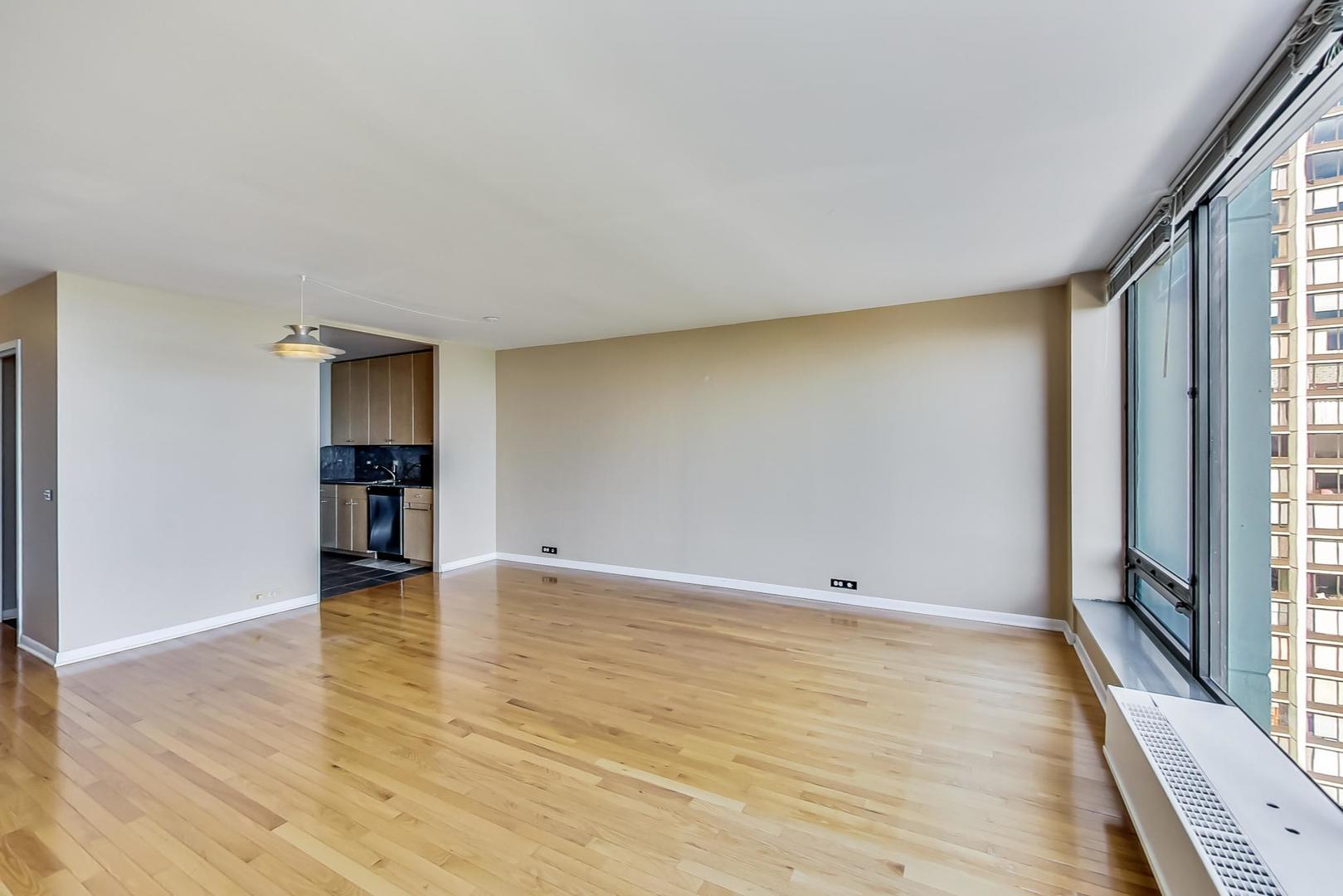 5445 North Sheridan Road, Unit 1706 Chicago, IL 60640 - Photo 6 of 26 a view of empty room with wooden floor and fan