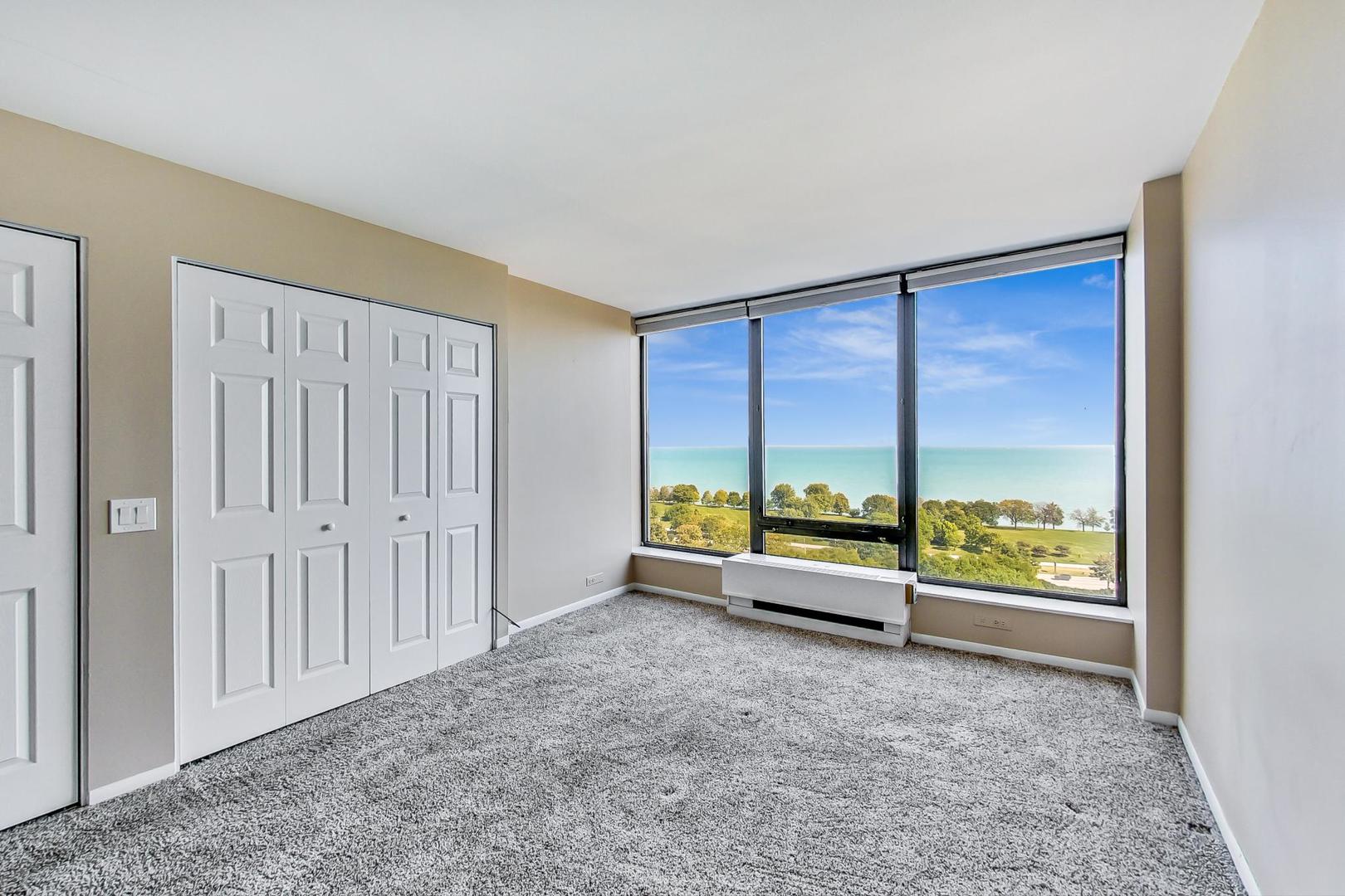 5445 North Sheridan Road, Unit 1706 Chicago, IL 60640 - Photo 10 of 26 an empty room with large windows