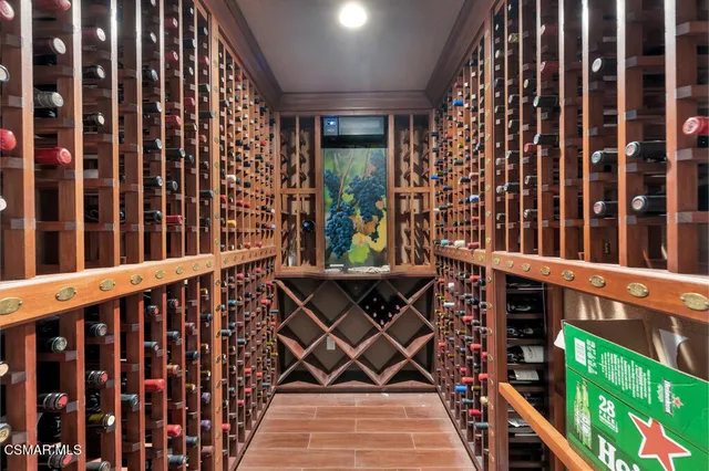 a kitchen with stainless steel appliances granite countertop a kitchen island hardwood floor and chairs