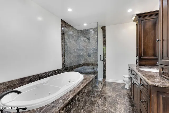 a view of a backyard with table and chairs plants and trees