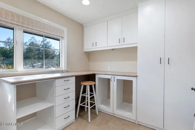 a front view of a house with garden and patio