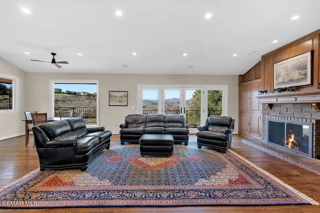 a dining room with furniture a chandelier and wooden floor