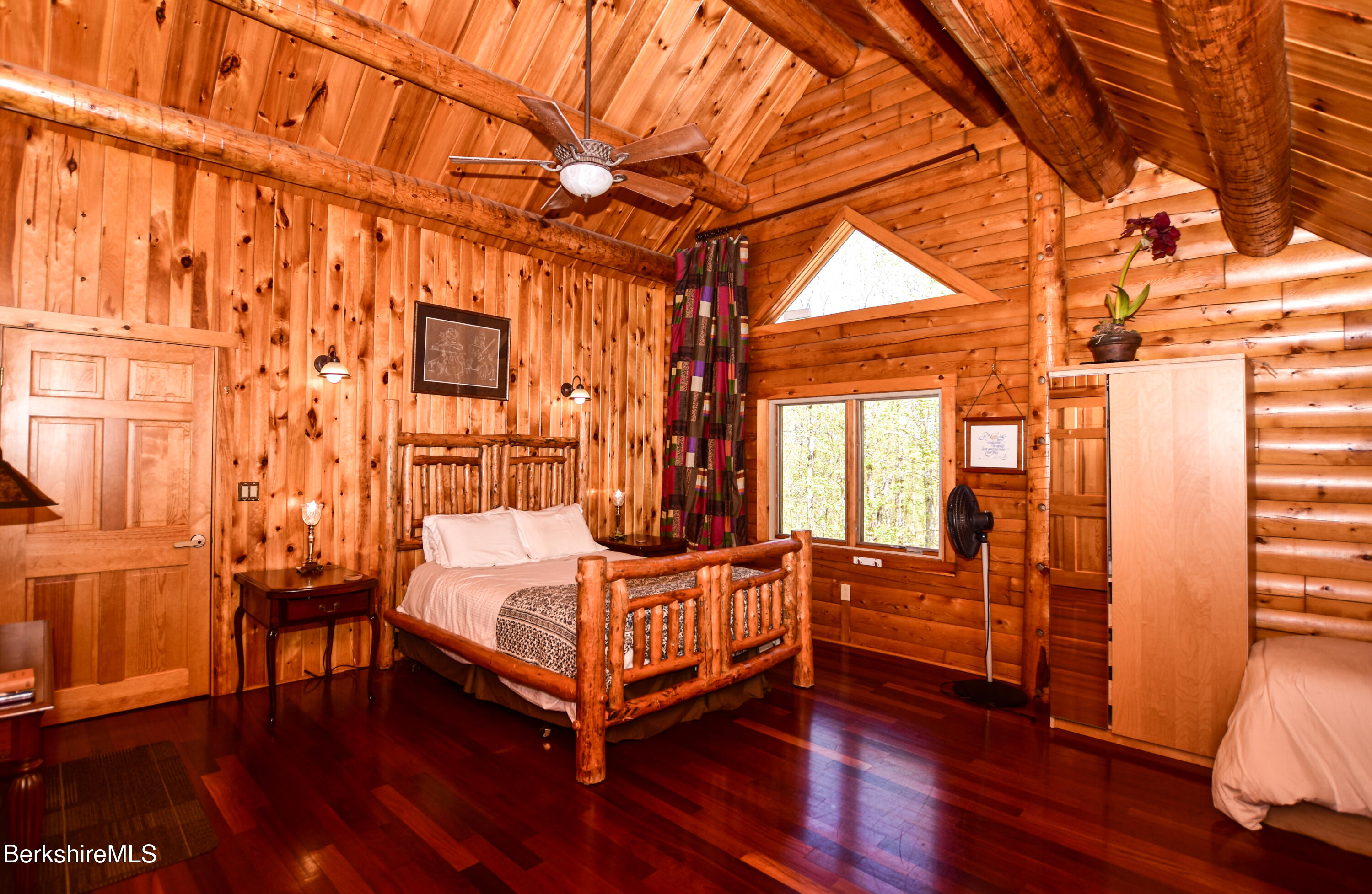 233 Algerie Road Becket, MA 01223 - Photo 28 of 48 a bedroom with a bed and wooden floor