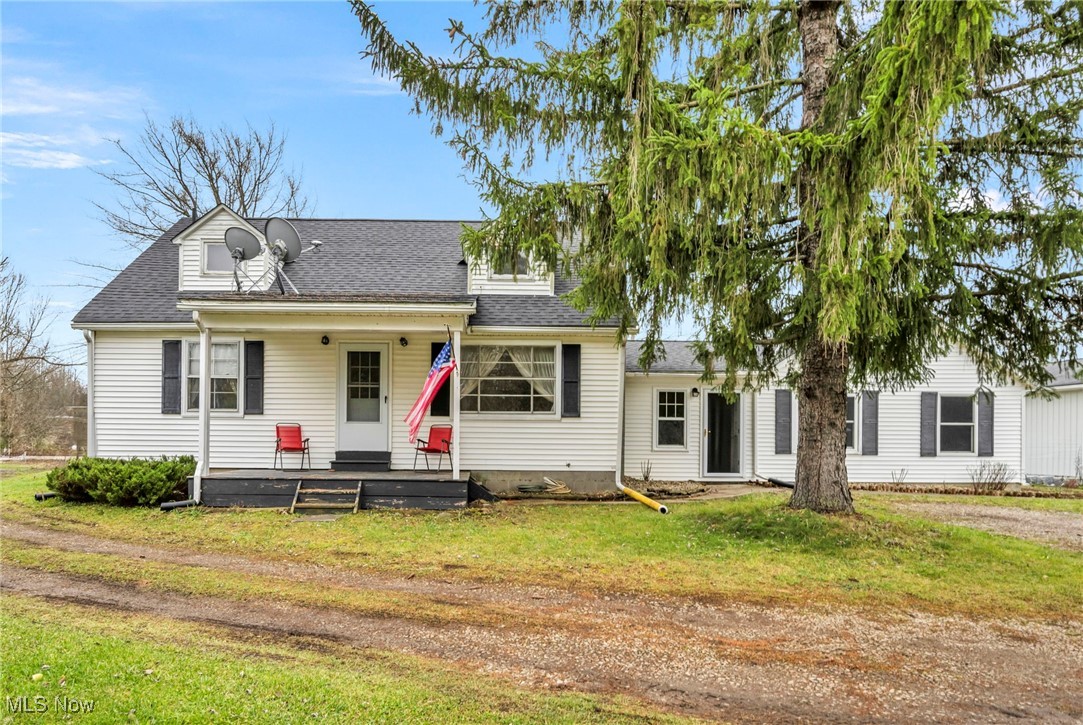 9982 Crow Road Litchfield, OH 44253 - Photo 1 of 41 View of front of house featuring a front lawn and covered porch