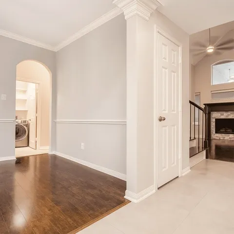 a view of a livingroom with wooden floor and a fireplace