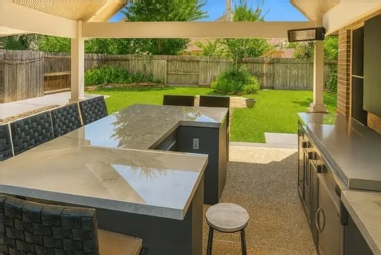 a view of a backyard with table and chairs potted plants