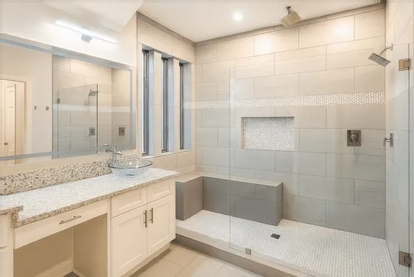 a bathroom with a granite countertop sink mirror and shower
