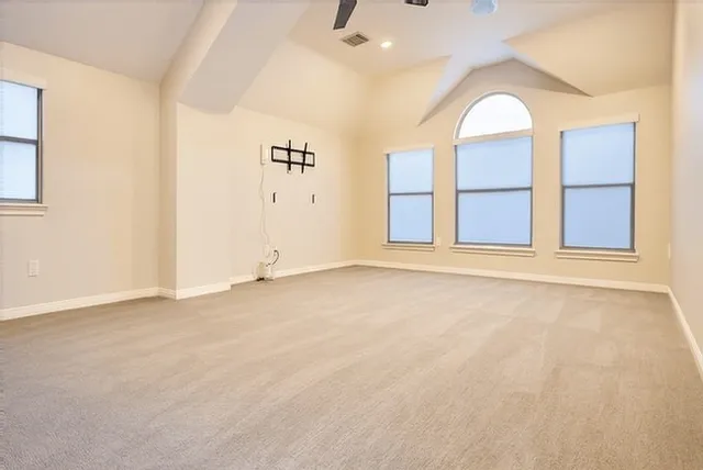 an empty room with windows and closet
