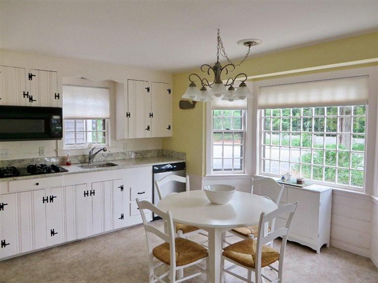 157 Lower County Road West Harwich, MA 02671 - Photo 4 of 14 a kitchen with granite countertop a sink dining table and chairs