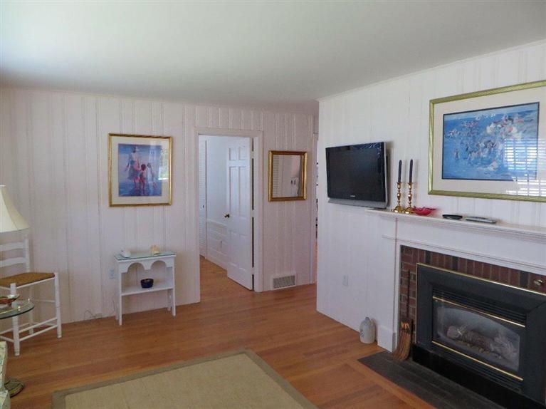 157 Lower County Road West Harwich, MA 02671 - Photo 6 of 14 a living room with furniture and a fireplace