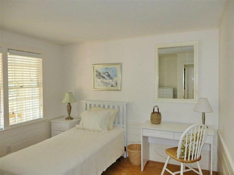 157 Lower County Road West Harwich, MA 02671 - Photo 7 of 14 a bedroom with a bed and a table with mirror