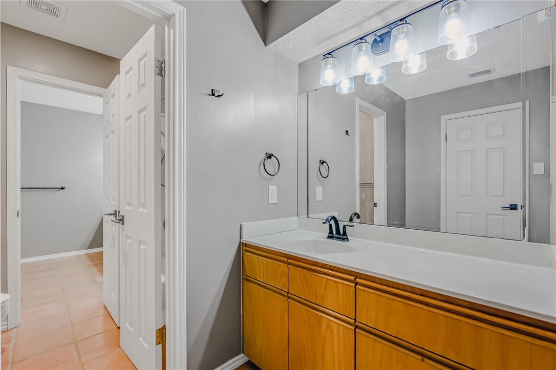 5917 Harvest Hill Road Corpus Christi, TX 78414 - Photo 31 of 40 a bathroom with a sink and a mirror