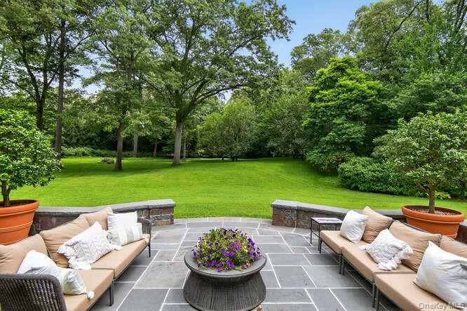 343 Chicken Valley Road Glen Head, NY 11545 - Photo 43 of 49 a view of a patio with couches potted plants and a big yard