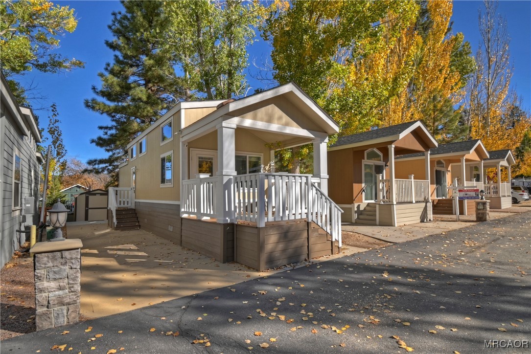 a view of a house with a small yard and wooden fence