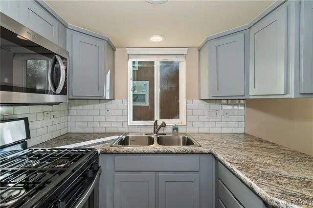 a kitchen that has a sink and a stove