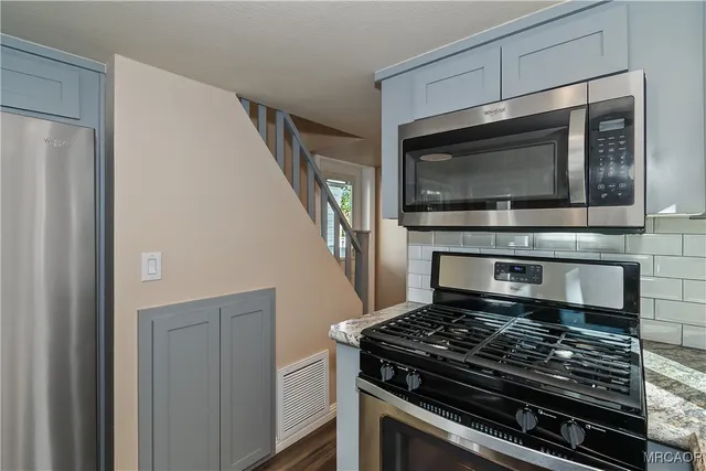 a kitchen with a stove and a microwave