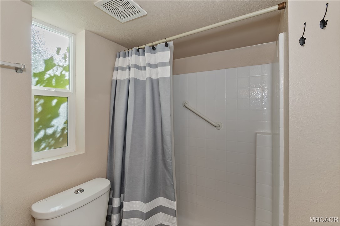547 Alden Road, Unit RV5 Big Bear Lake, CA 92315 - Photo 17 of 34 a bathroom with a shower a toilet and a sink