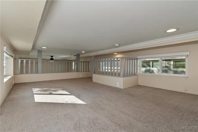 a front view of a house with a tree