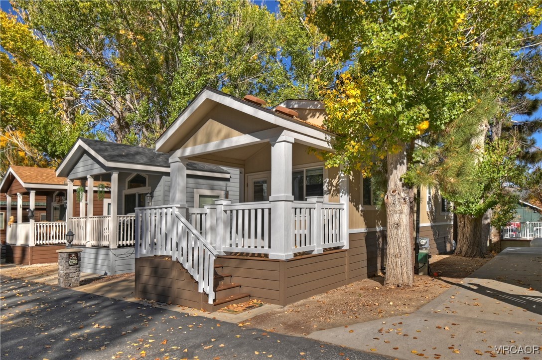 547 Alden Road, Unit RV5 Big Bear Lake, CA 92315 - Photo 33 of 34 a view of a house with a small yard and wooden fence