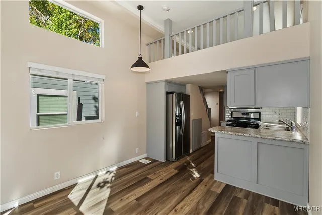 a kitchen with kitchen island a counter top space a sink and a refrigerator