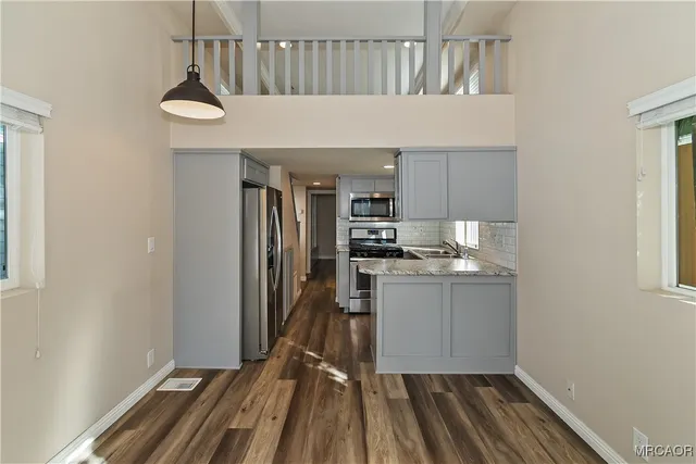 a kitchen with sink and refrigerator