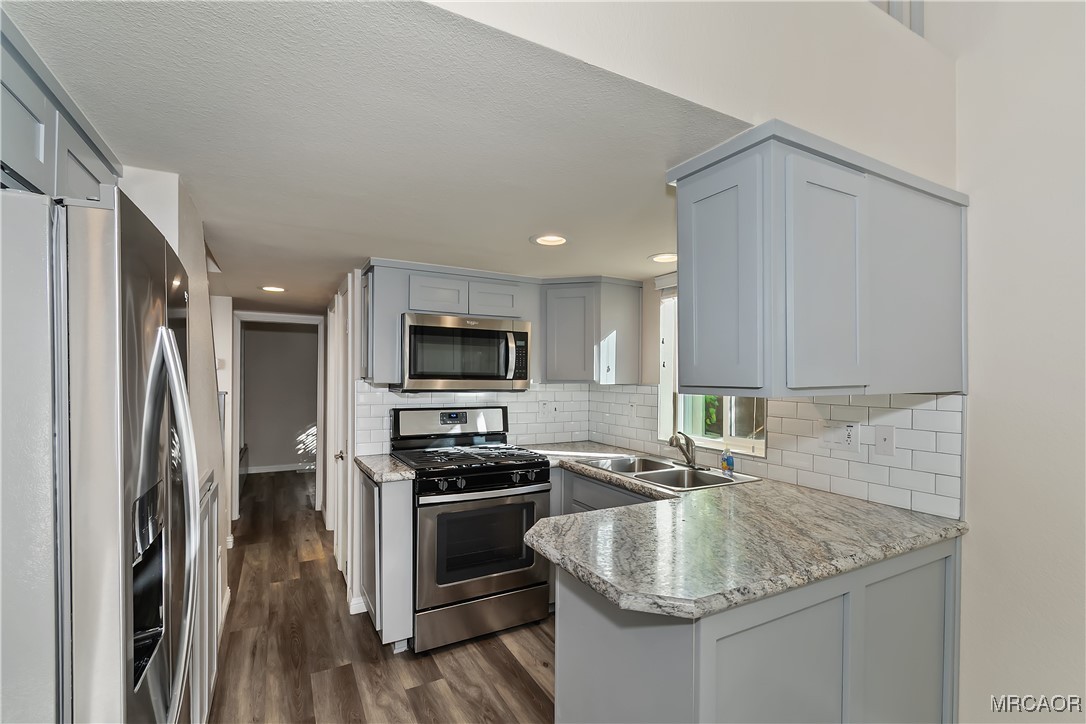 547 Alden Road, Unit RV5 Big Bear Lake, CA 92315 - Photo 9 of 34 a kitchen with stainless steel appliances granite countertop a sink stove and refrigerator