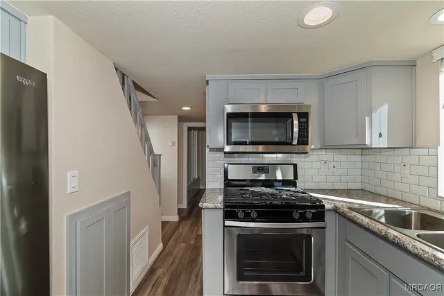 a kitchen with a stove and a microwave