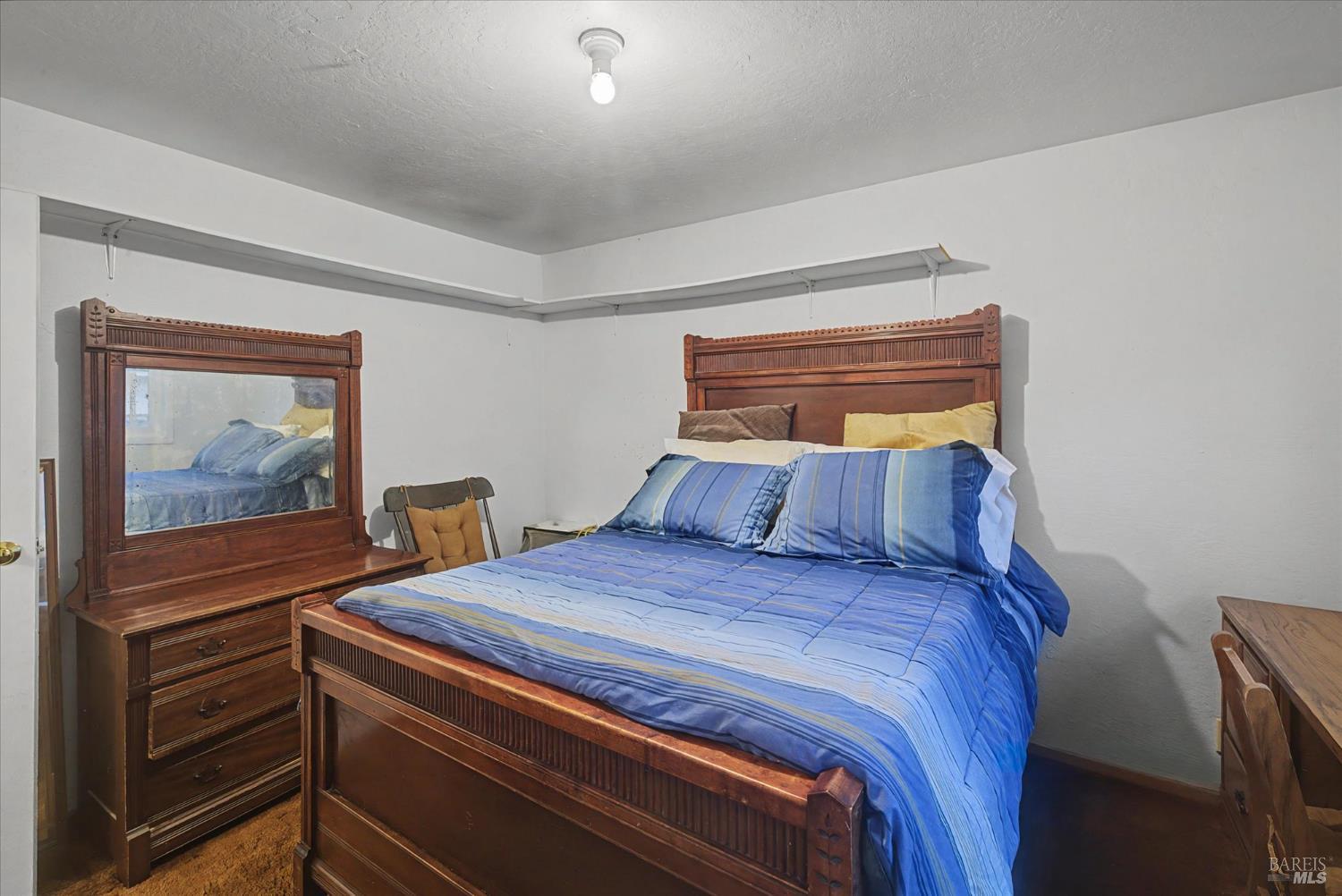 1763 E Street Napa, CA 94559 - Photo 15 of 31 a bedroom with a bed and a refrigerator