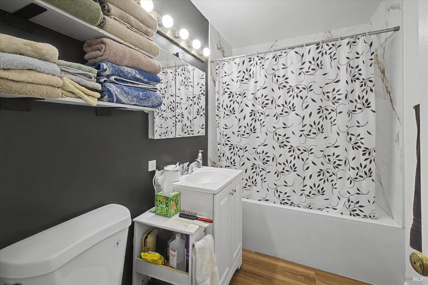 1763 E Street Napa, CA 94559 - Photo 17 of 31 a bathroom with a toilet and shower curtain