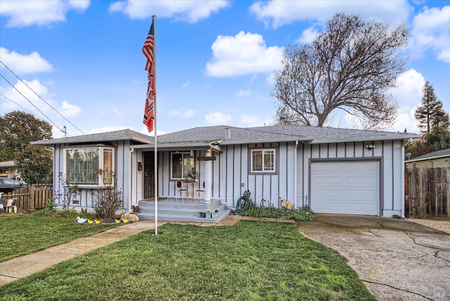 1763 E Street Napa, CA 94559 - Photo 2 of 31 a front view of a house with a yard and garage