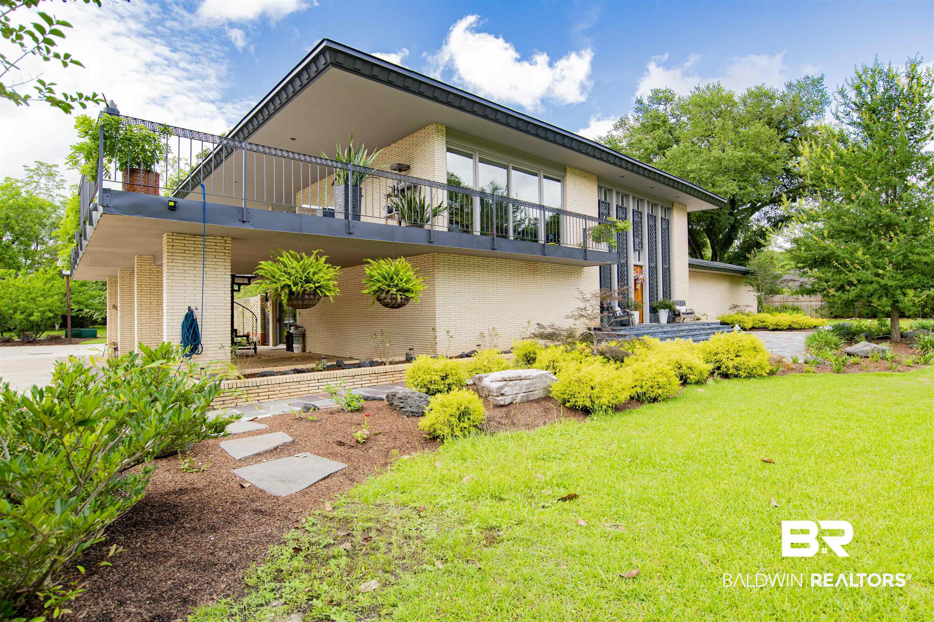 809 Bernard Circle Mobile, AL 36693 - Photo 49 of 75 Mid-century modern exterior featuring a light brick facade and a flat roofline