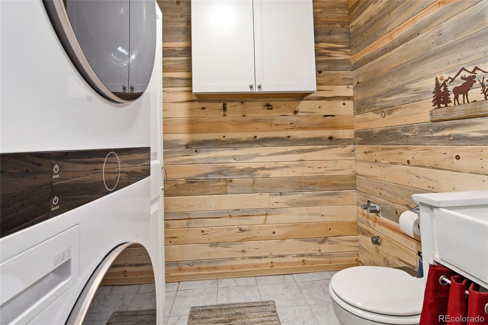 185 Alice Road Idaho Springs, CO 80452 - Photo 23 of 43 a bathroom with a toilet a sink and mirror