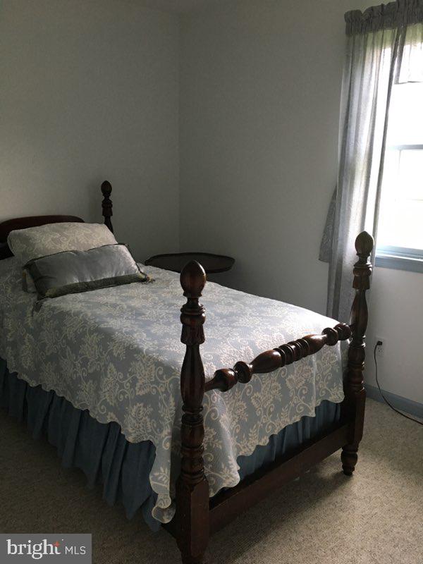 20256 Nanticoke Road Nanticoke, MD 21840 - Photo 18 of 26 a bedroom with a bed and window