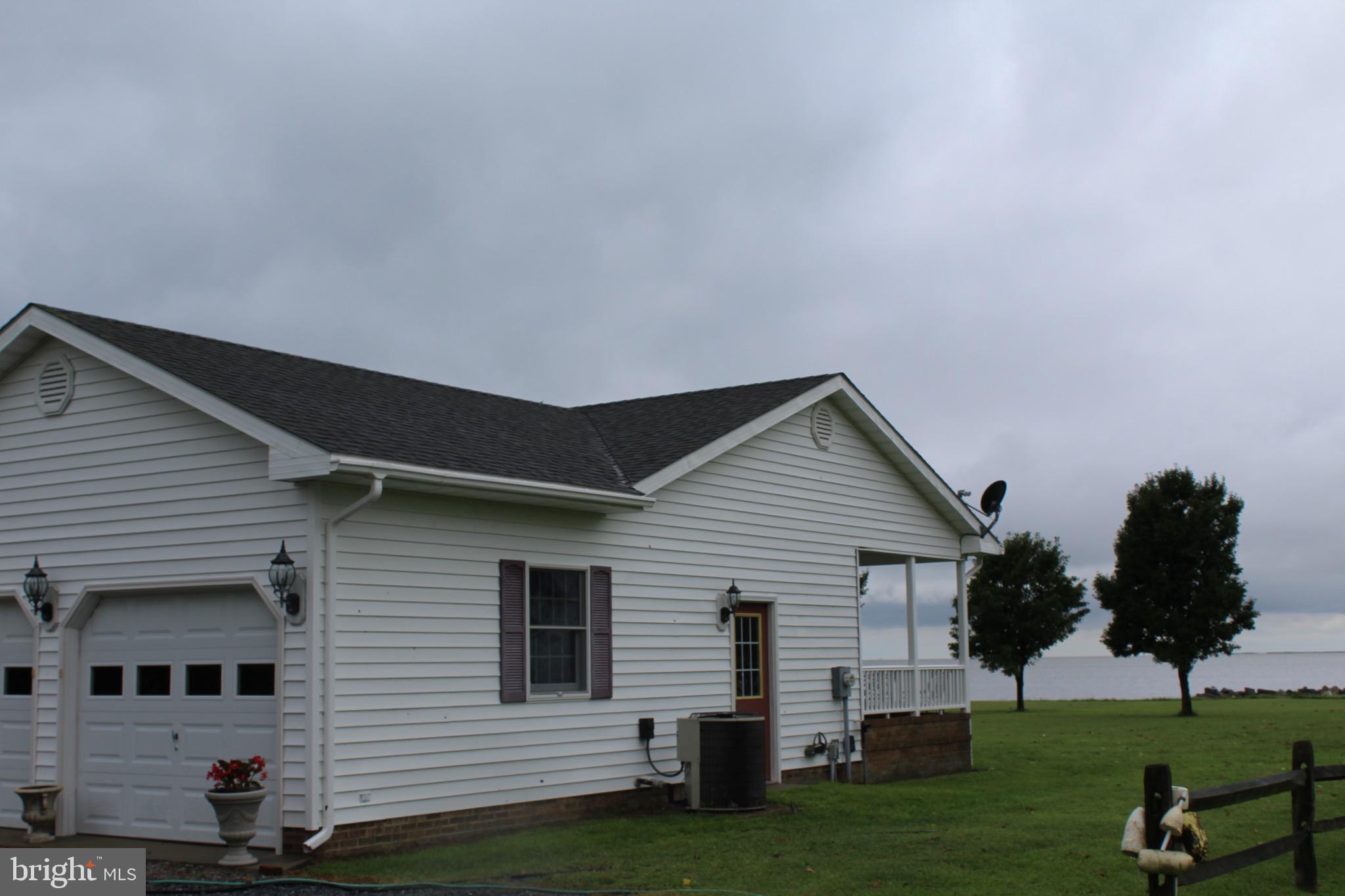 20256 Nanticoke Road Nanticoke, MD 21840 - Photo 20 of 26 a front view of a house with a garden