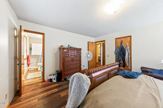 a bedroom with furniture and a large window